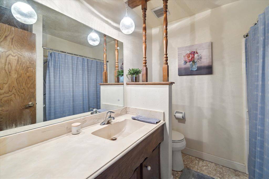 Full Bath with large vanity and shower/tub combo.