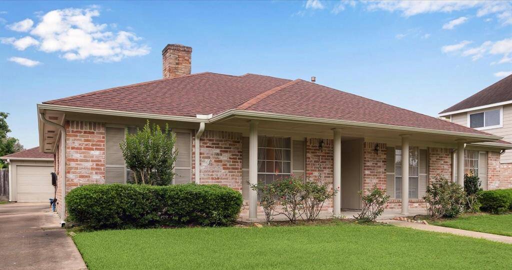 View of the drive to detached 2 Car Garage, back covered entry and backyard area.