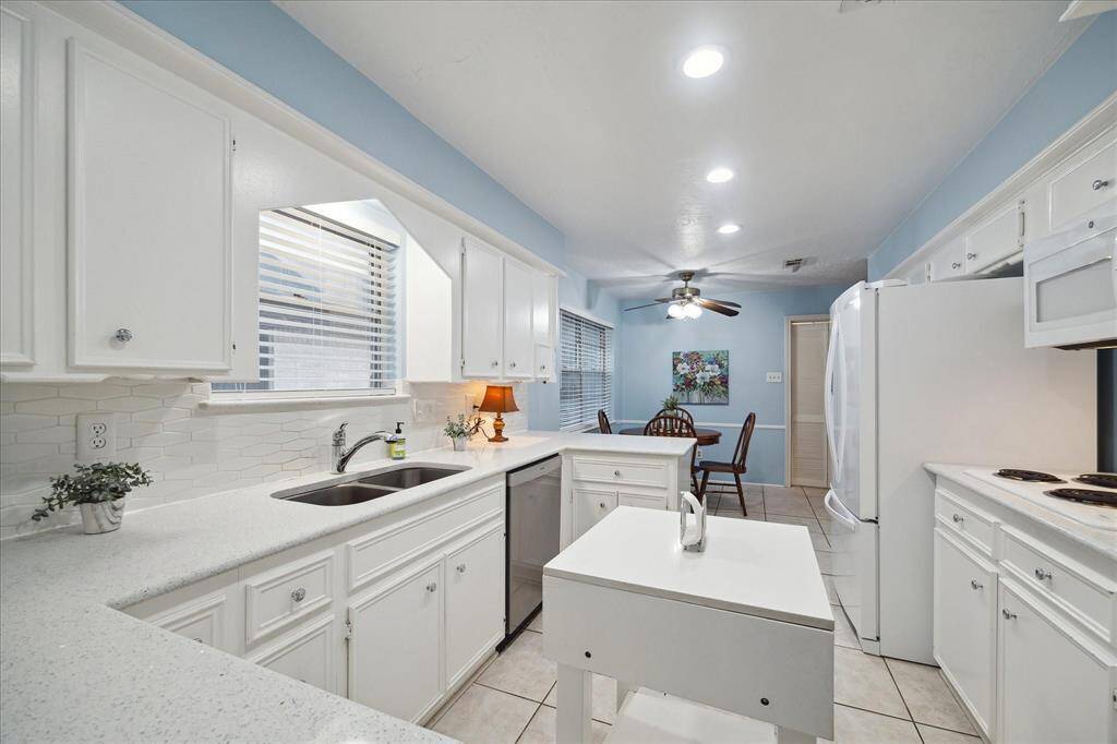 Updated Kitchen with tons of cabinetry for storage and counter tops for entertaining and prep.