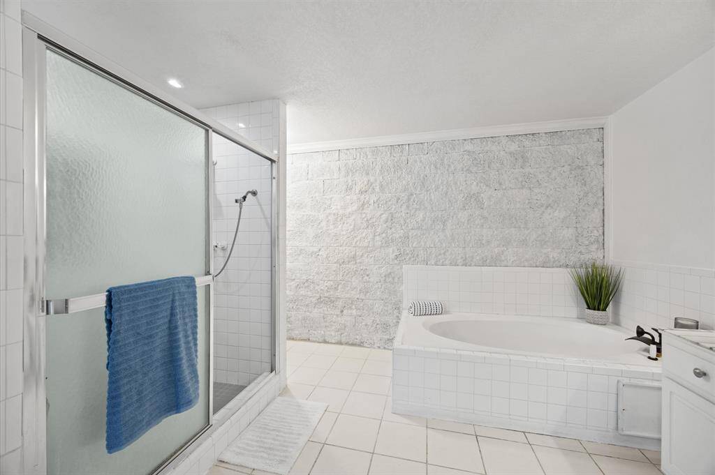 Indulge in relaxation with a spa tub and separate shower in the primary bathroom.