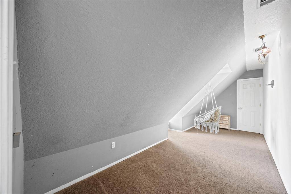 Discover a charming bonus room off the bedroom, perfect for a creative retreat or relaxing nook.