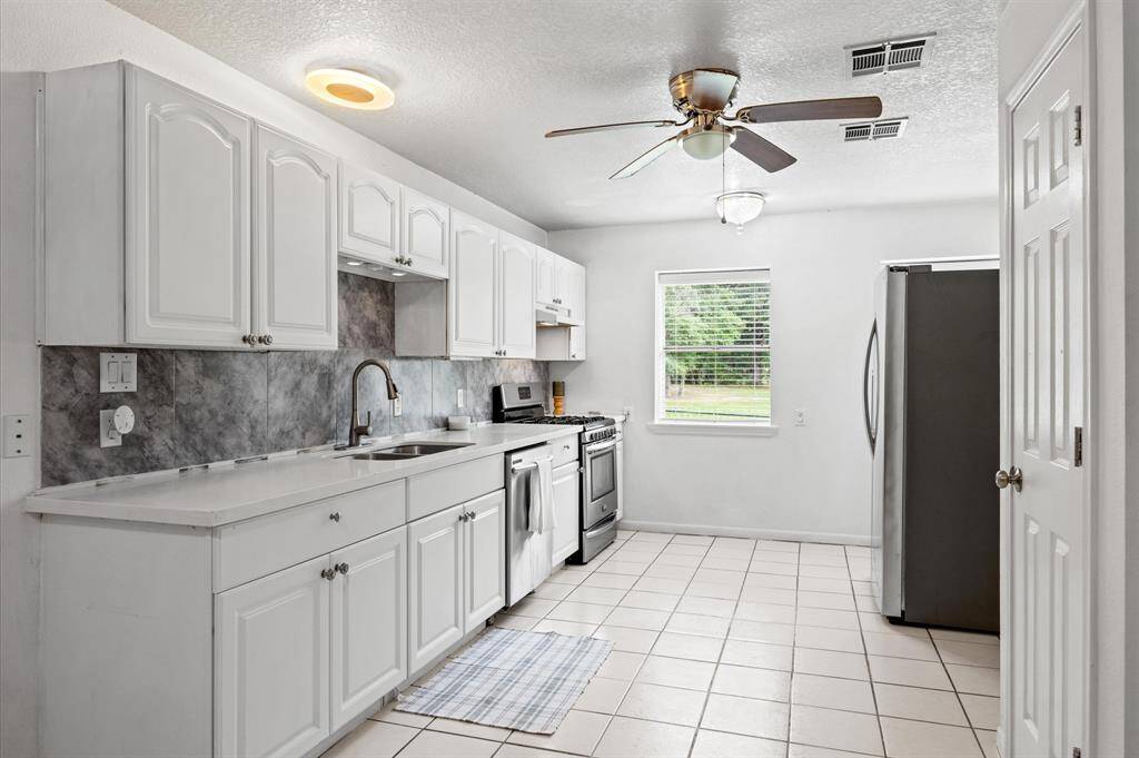 Modern kitchen with sleek appliances and breathtaking views of lush greenery.