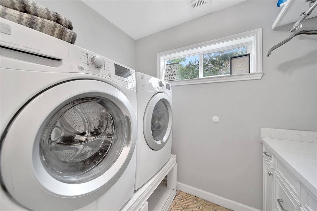 View of laundry room connected to primary bathroom.