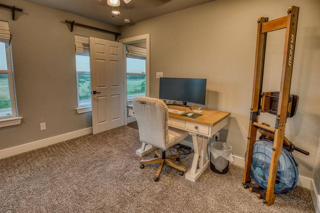 Upstairs bedroom currently being used as a home office.  The walk-in attic space is already roughed-in for an upstairs bathroom