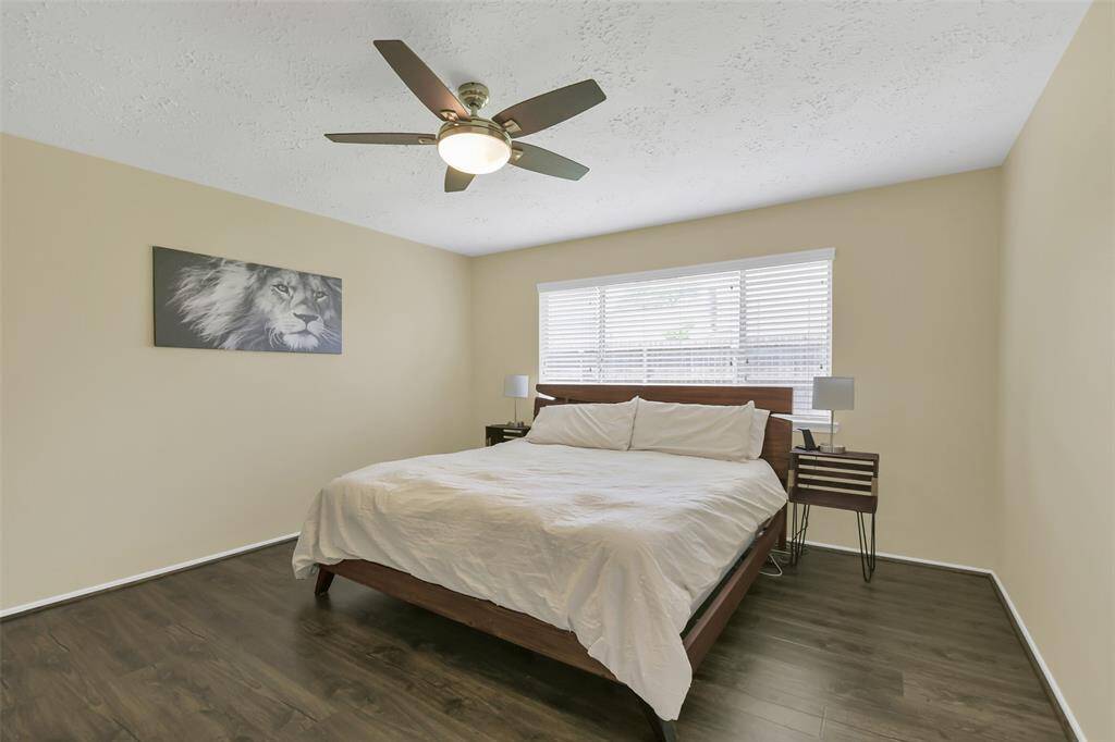 Spacious primary bedroom shown with king size bed