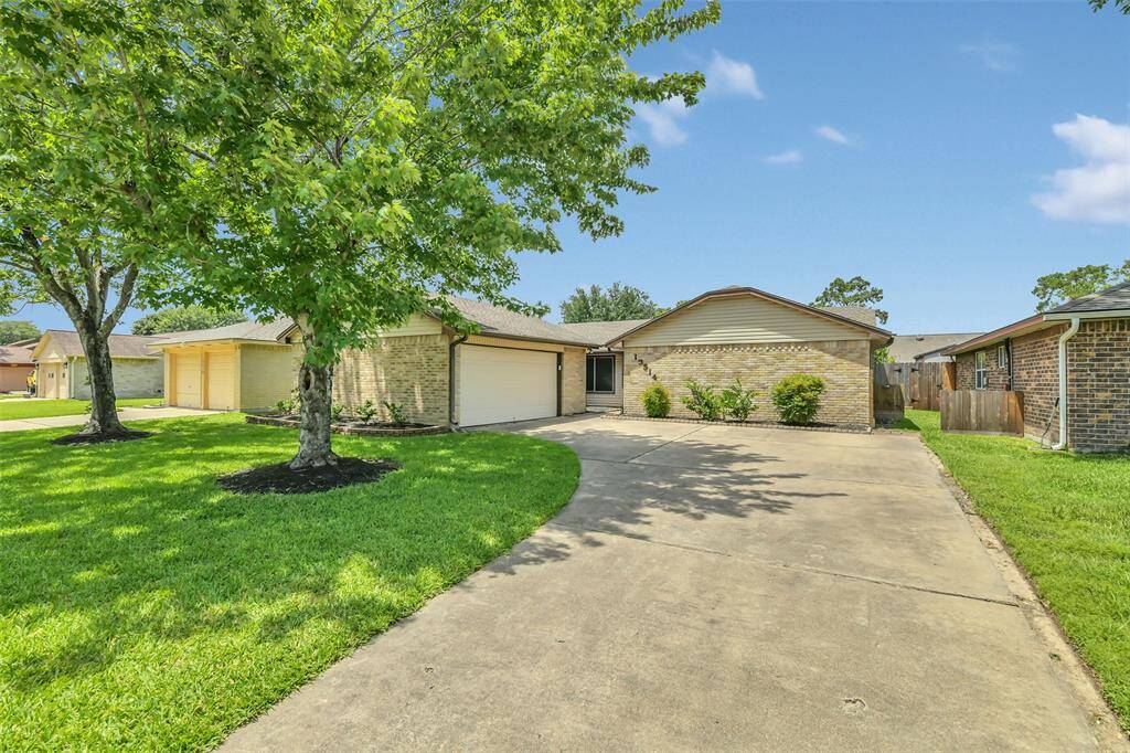Charming one-story home with mature shade trees and a long driveway- perfect for extra parking