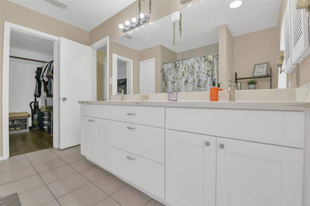 Another view of the primary bath and closet