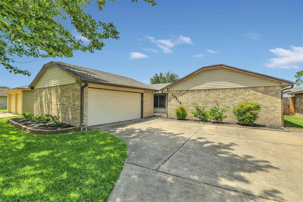 Another view of this recently updated home with gutters and beautiful lawn