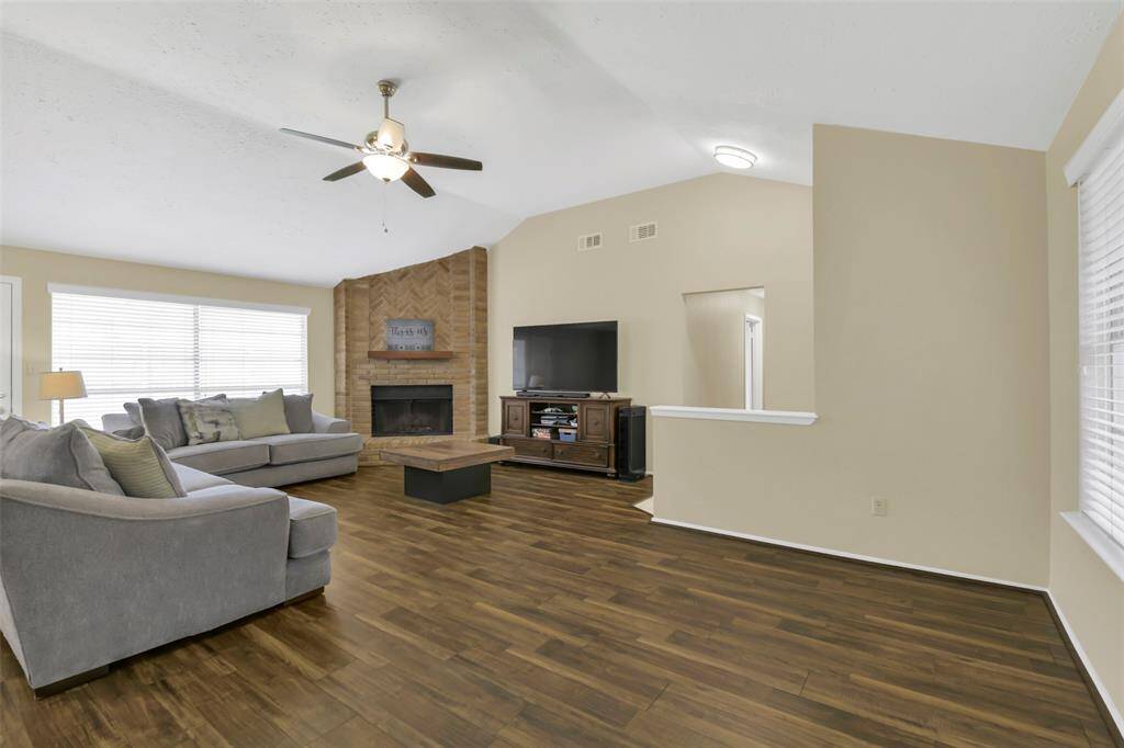 Natural light, ceiling fan and a wood burning fireplace set this room off!