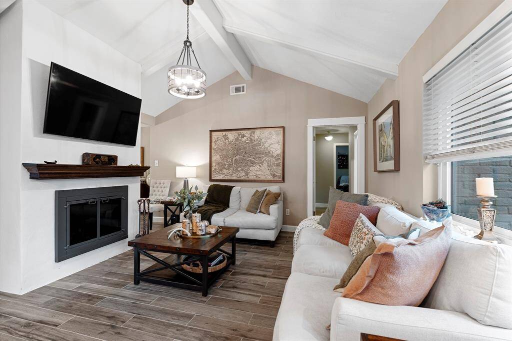 Living room featuring a striking white brick fireplace, adding a distinctive and stylish focal point for gatherings and relaxation.