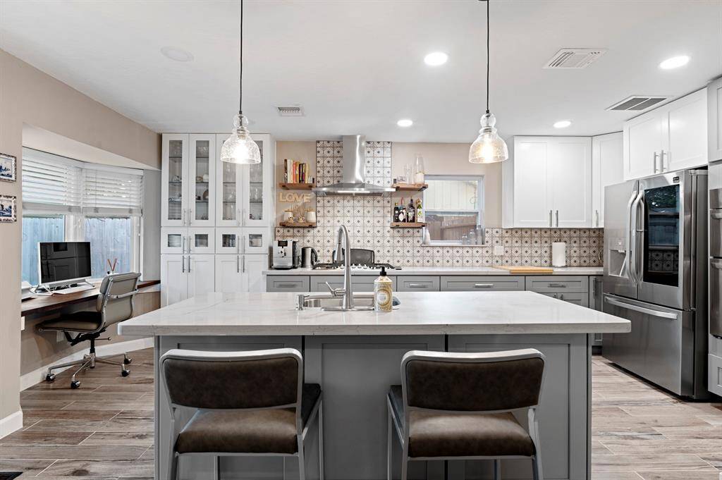 Upgraded kitchen with a modern island, offering additional workspace and a stylish focal point for cooking and entertaining.