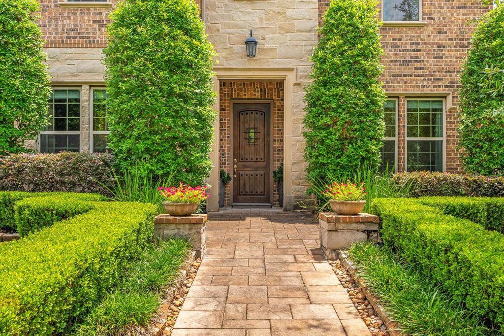 Welcoming front entry lushly landscaped