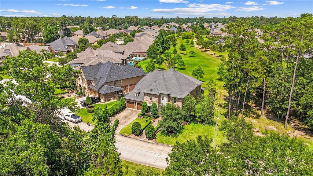 Aerial view of the front of the home and green space