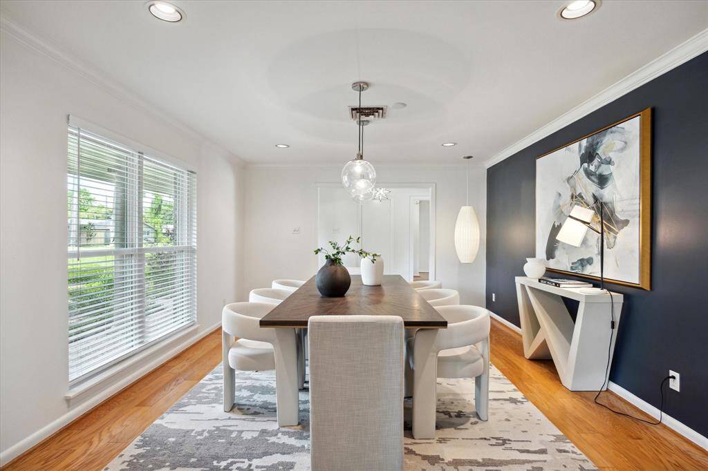 Featuring an accent wall and scenic views of the front yard, this dining room sets the stage for memorable moments with family and friends.