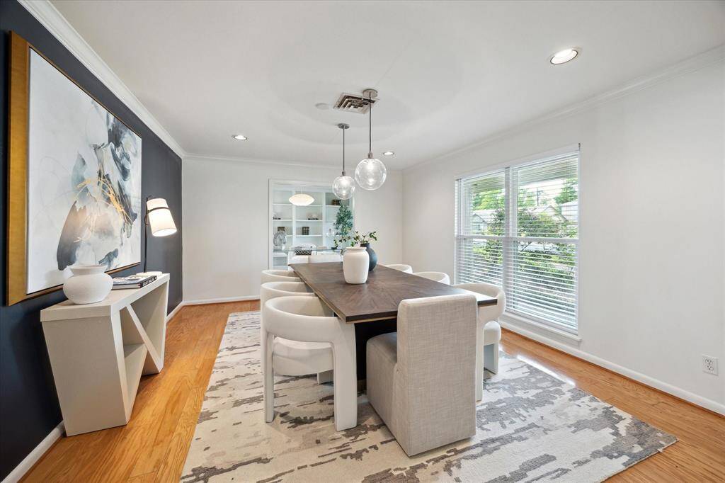 Expansive windows in the dining room frame picturesque views of the front yard.