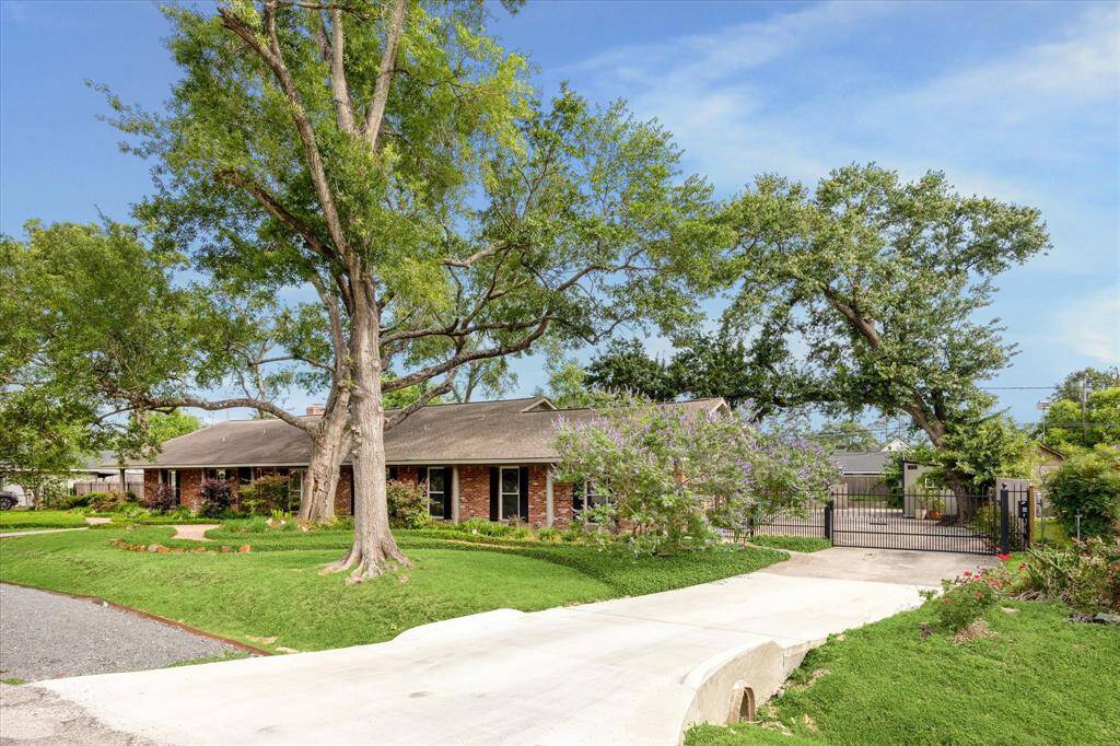 An automatic gate opens to the massive backyard oasis with a chicken coop, storage shed and plenty of green space.