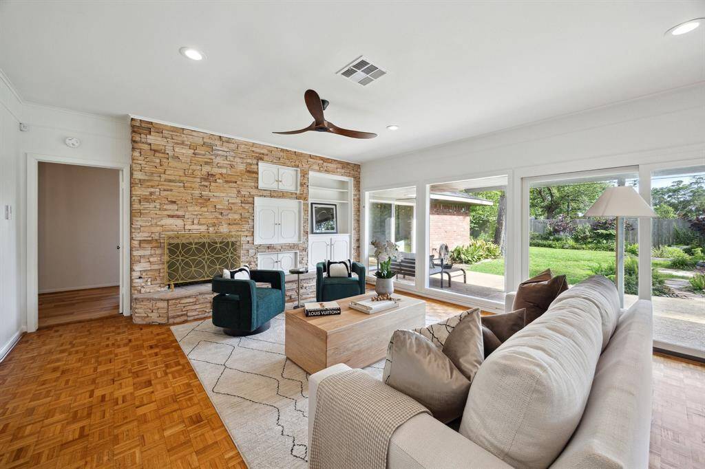 This home features charming original details like the brick wall and fireplace, offering a mid-century vibe.