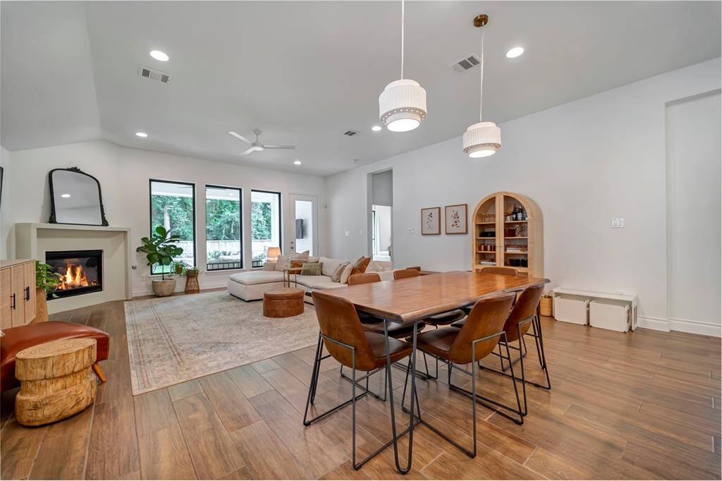 The dining room features custom pendant lighting.