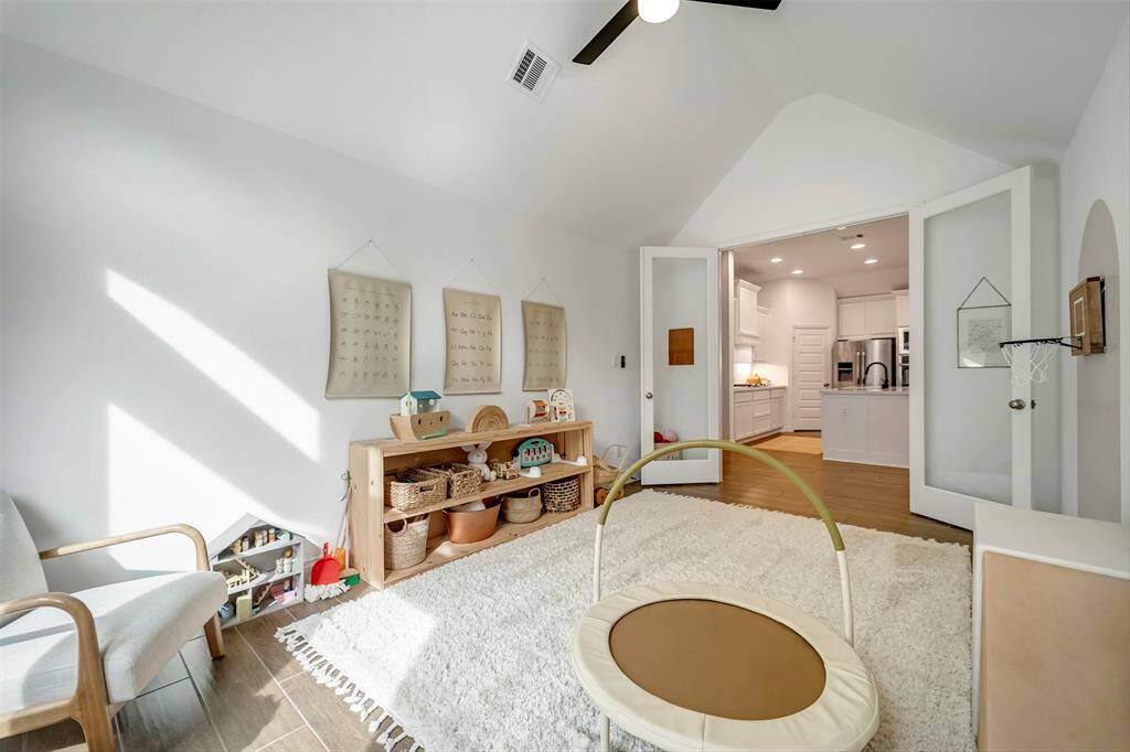 The flex room features French doors and is currently being used as a playroom.