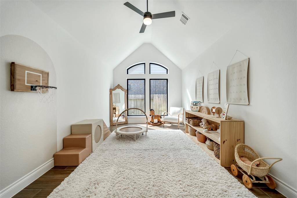 The spacious flex room features tall vaulted ceilings.