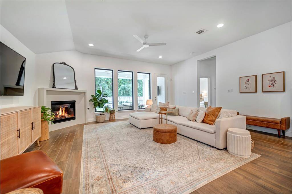 The family room features a gas corner fireplace and large windows.