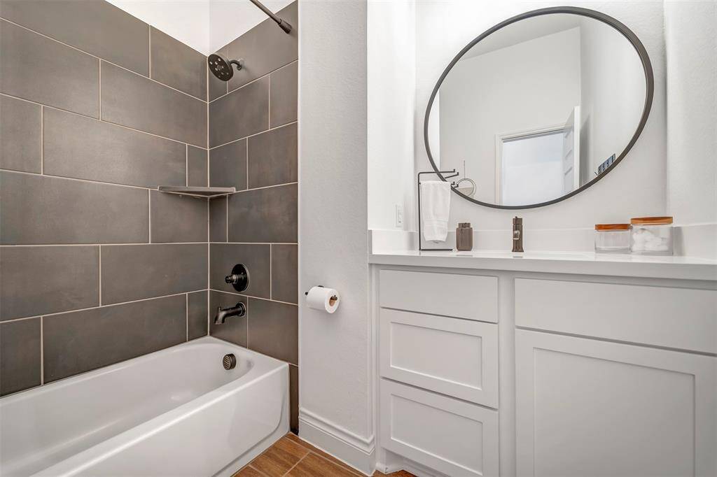 Upgraded hall bath with tile tub surround between the 2nd and 3rd bedrooms.