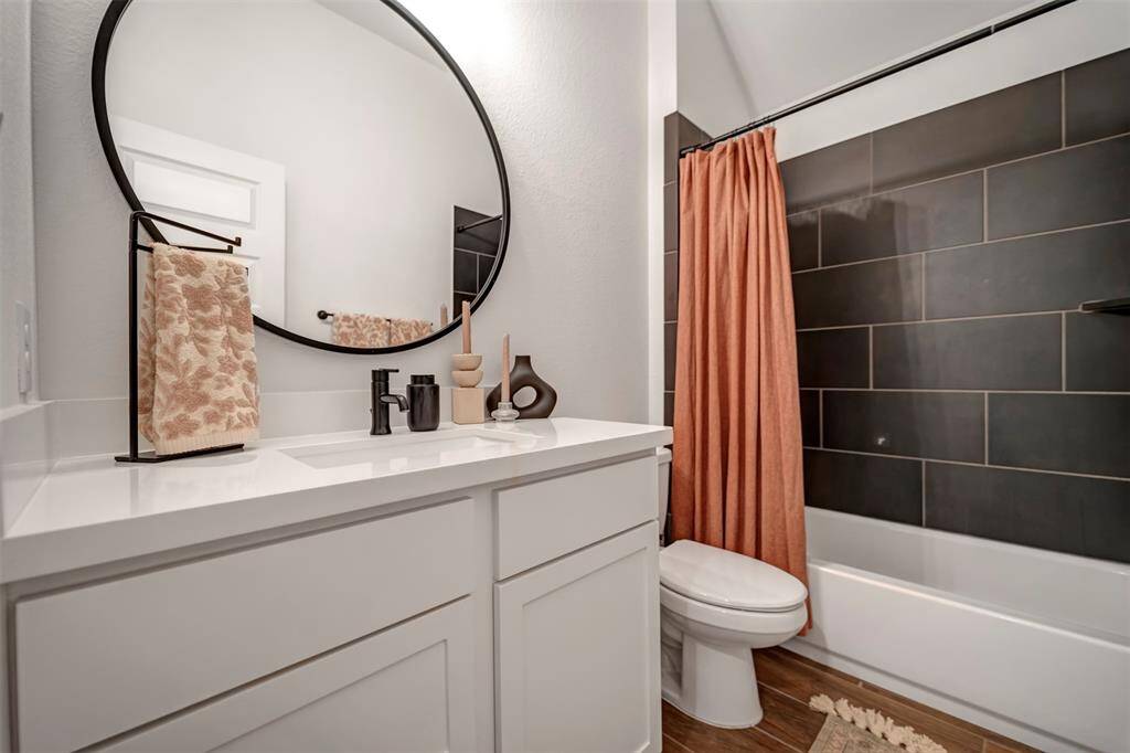 Upgraded full bath with tile tub surround  with easy access to the 4th bedroom suite.
