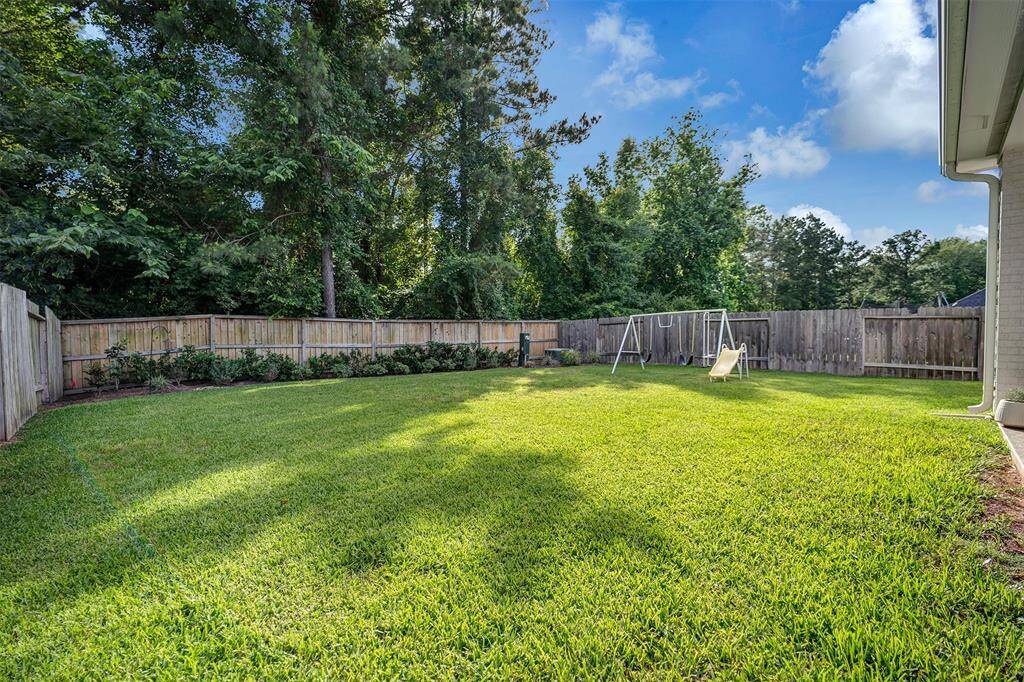 Enjoy a lush, private backyard with ample space for a pool.