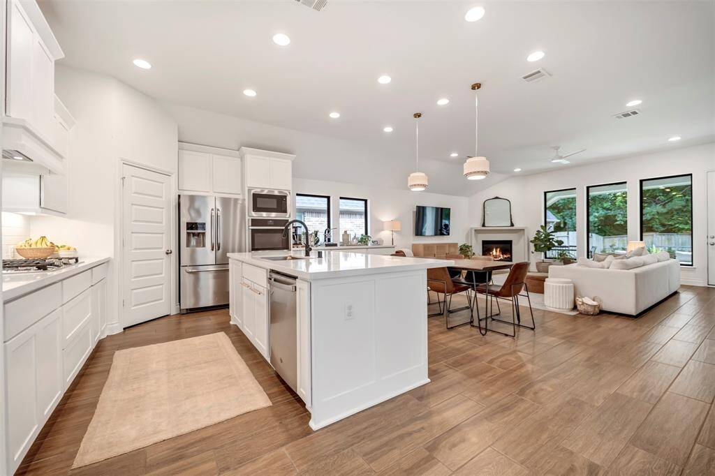 Expansive island, double oven, and stainless steel appliances.
