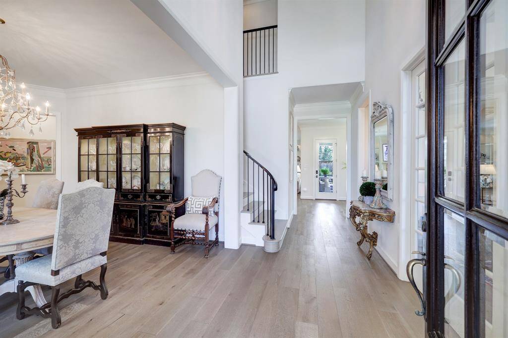 Stunning entry way with wood floors, tall ceilings and an abundance of natural light.