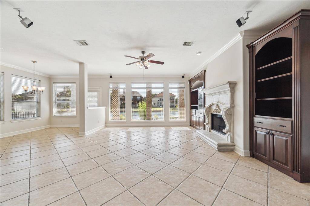 Living room beckons you in further with a wall of windows looking out onto the gorgeous back yard and lake.