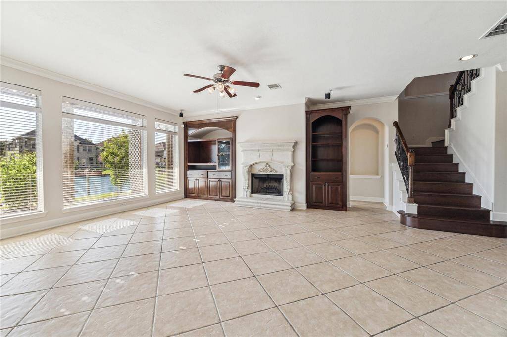 Custom built-ins and a stone fireplace are just some of the upgraded touches throughout the home. Surround sound speakers included.