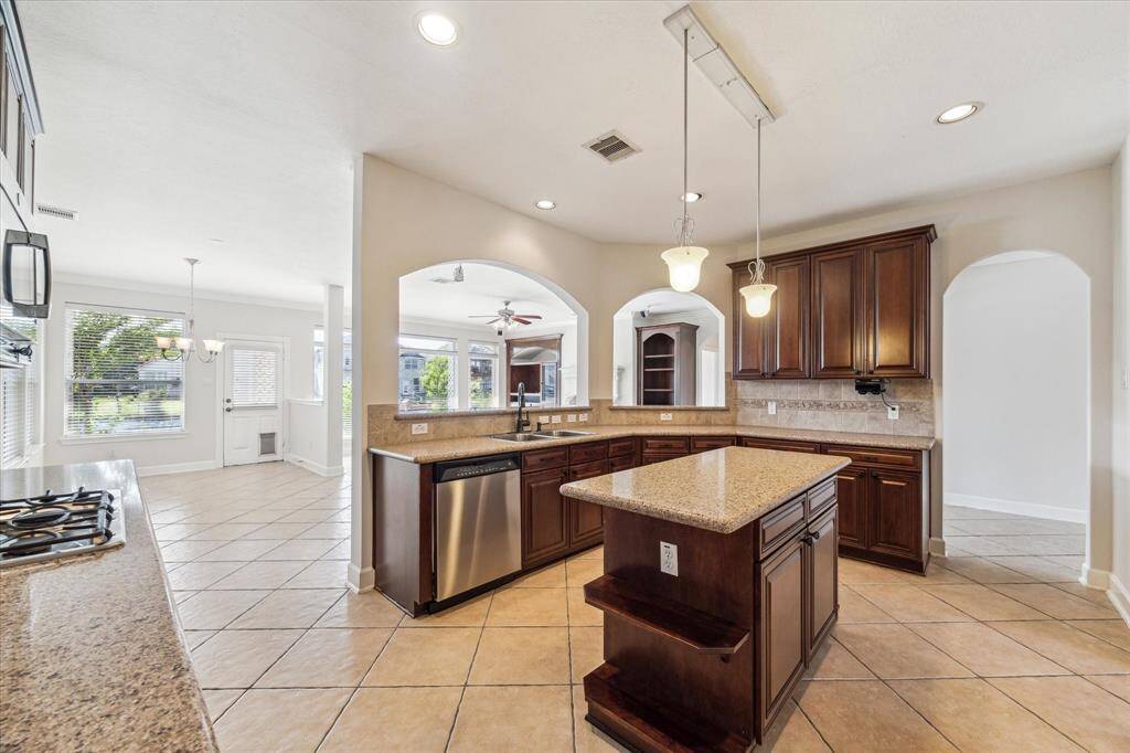 Spacious kitchen with granite countertops and center island for extra prep space.