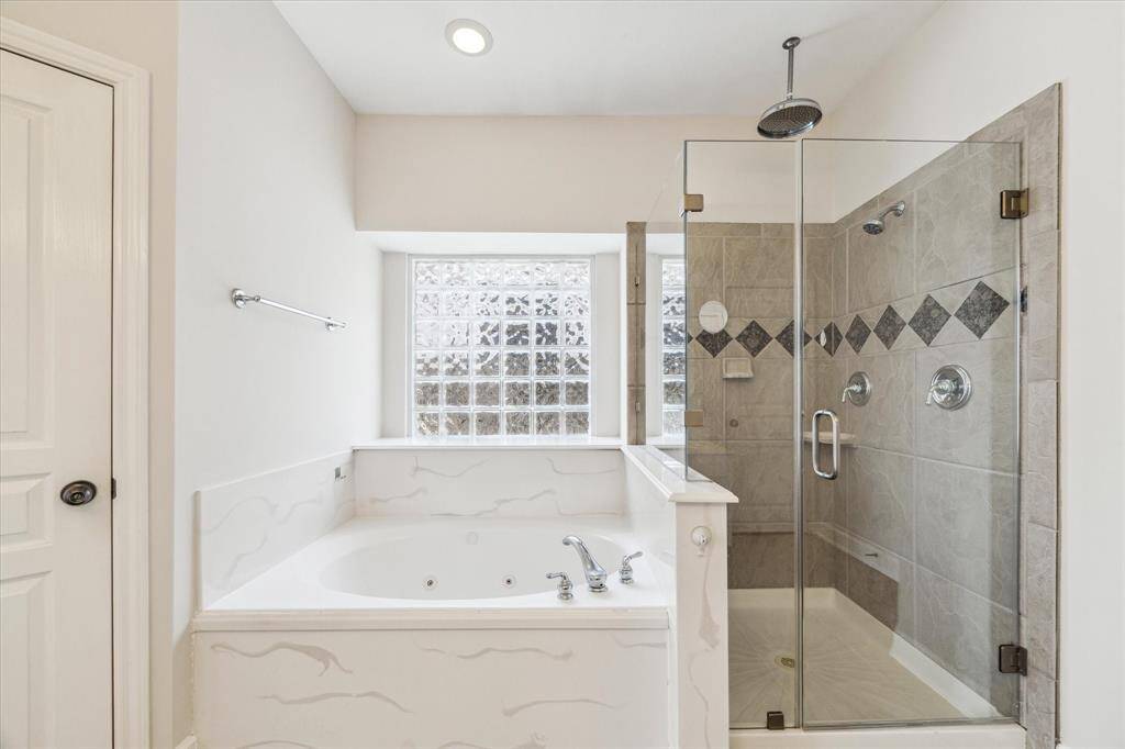 Jetted tub and all glass shower.