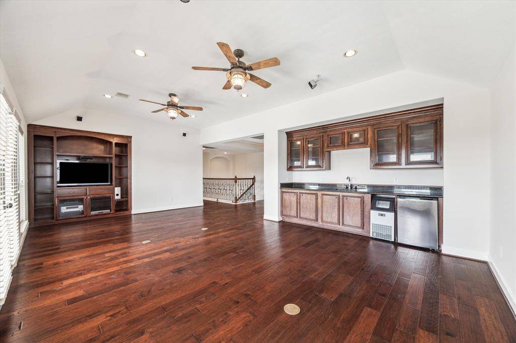 The second floor game room/living room is another of the  major upgrades the sellers made to the home. Custom built-ins including a full wet bar complete with sink, mini fridge and ice maker. This room also has surround sound and the speakers and the receiver are included.