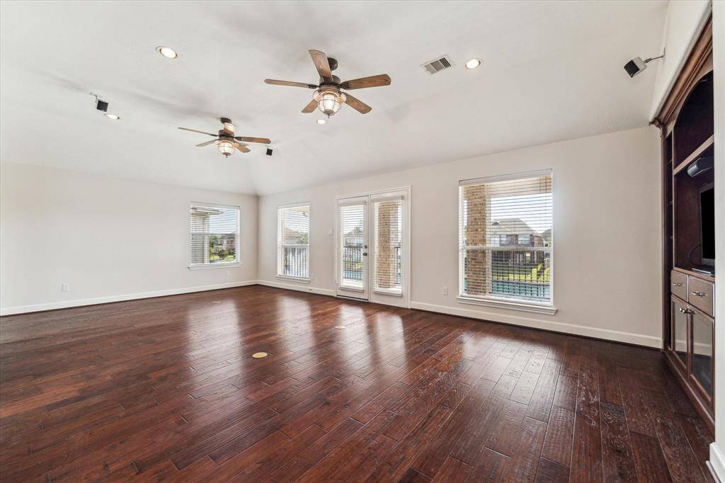 Wood floors run throughout the second floor living space. You have access to the extended covered porch.