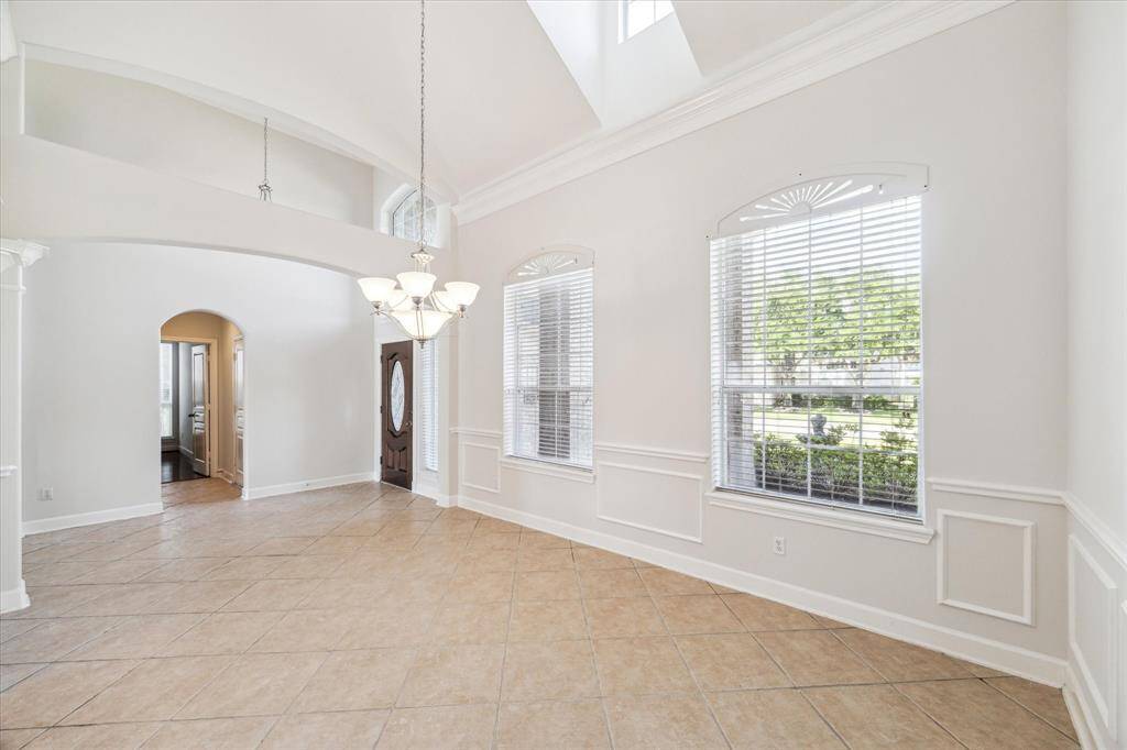 Another view of the dining room looking towards the entry and a hallway leading to the powder room and office/study.