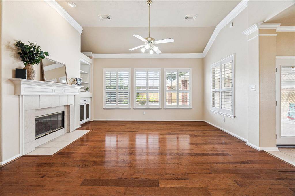 Large open living area with high ceilings and wood floors