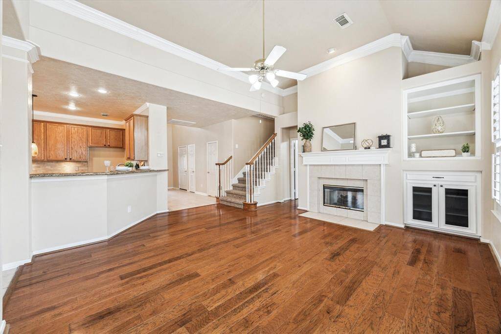 Open space with a two sided fireplace into the primary bedroom and custom built  shelves for your entertainment equiptment!