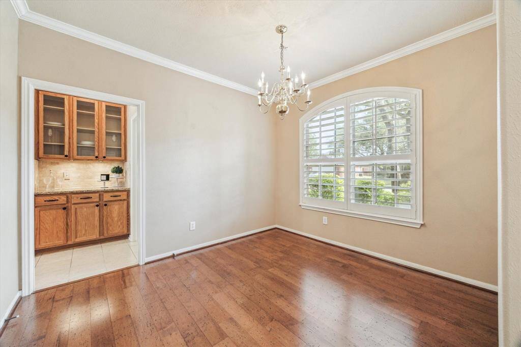 Large dining room in front of home that leads to butlers pantry and kitchen