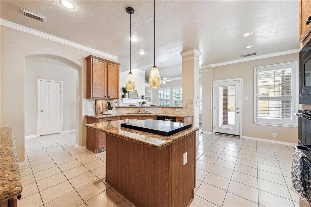 You can visit easily with all your guest while cooking in the kitchen, Stove in center island with cover for the ability to use as serving space also.
