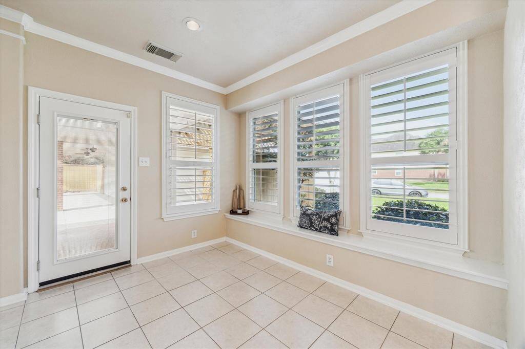 Breakfast seating with view of pool and beautiful yard.  Window seat for extra seating. Custom cushions will stay with home