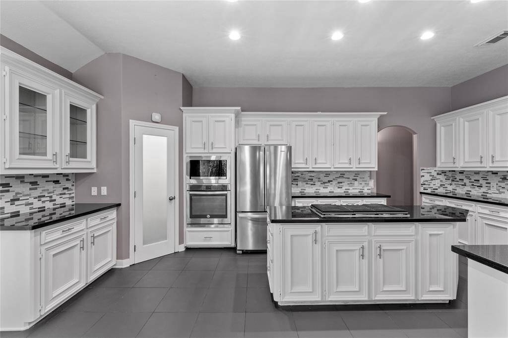 Kitchen has a lot of cabinets for storage