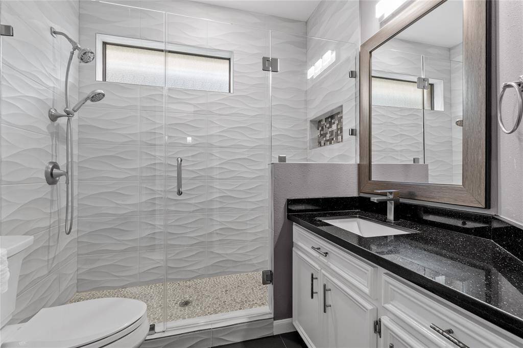 Stunningly remodeled secondary bathroom with granite countertops