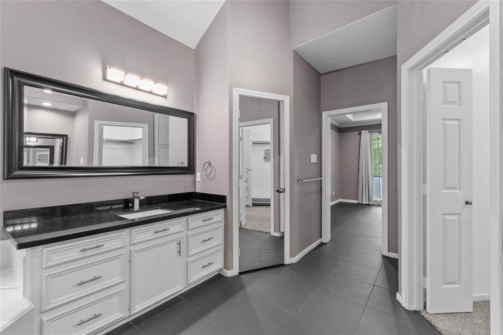 Separate vanities with granite countertops
