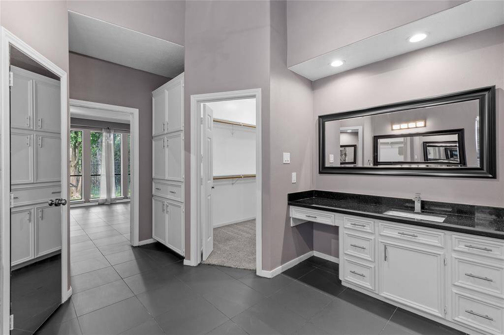 Separate vanities with granite countertops