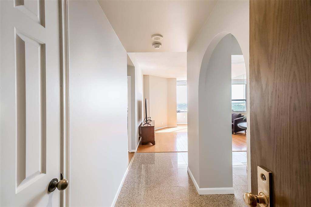 Welcome to 15 Greenway 11B. From the entry, the freshly updated kitchen with granite countertops overlooks the living area.