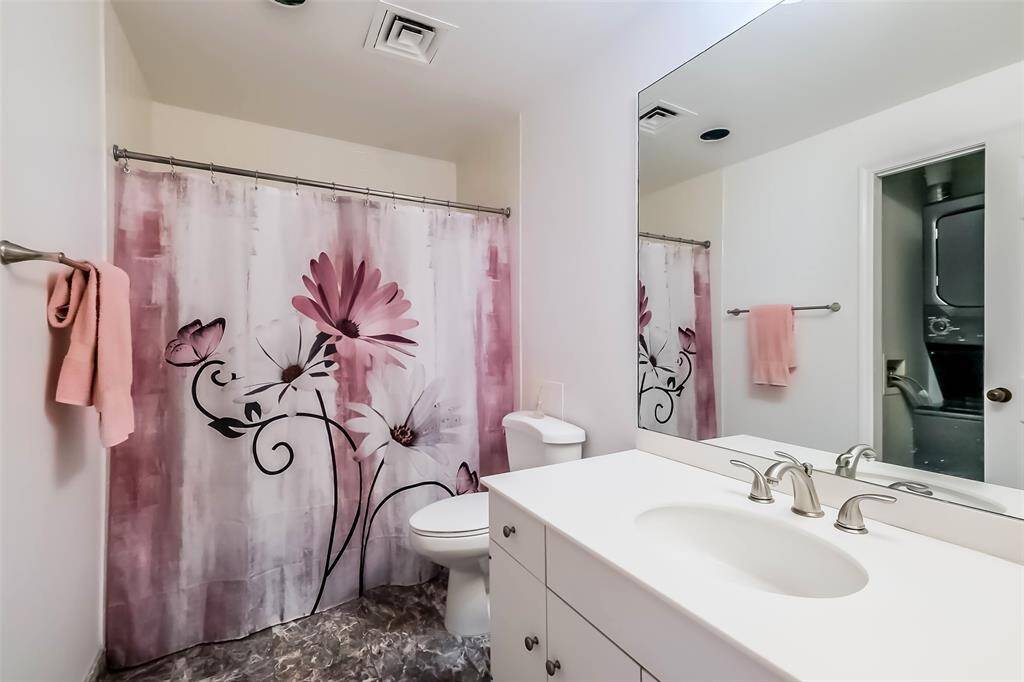 A guest bath with shower/tub is directly across from the secondary bedroom.