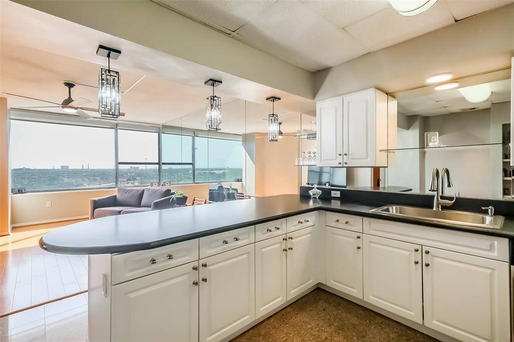 The delightful kitchen is full of storage and boasts stainless appliances .
