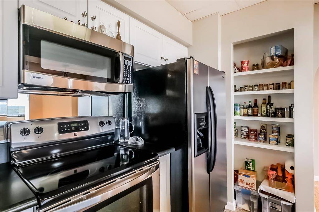An ample pantry completes the updated kitchen.